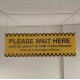 Please Wait Here Hanging Sign